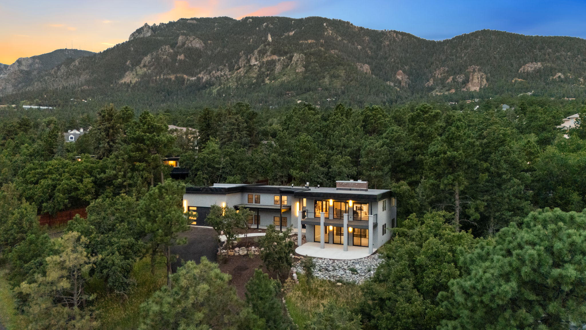 526 Penrose — aerial view at dusk with Cheyenne Mountain behind the house